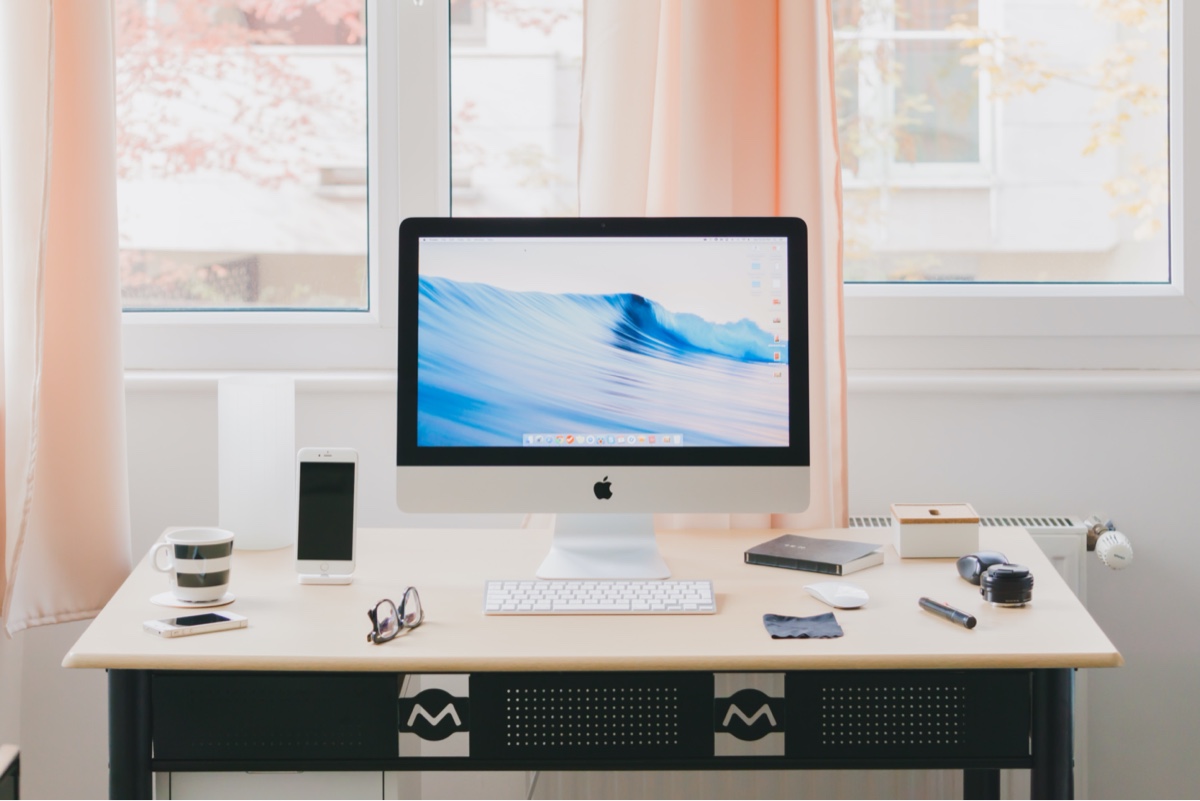 A bright home office setup with iMac on top of desk.