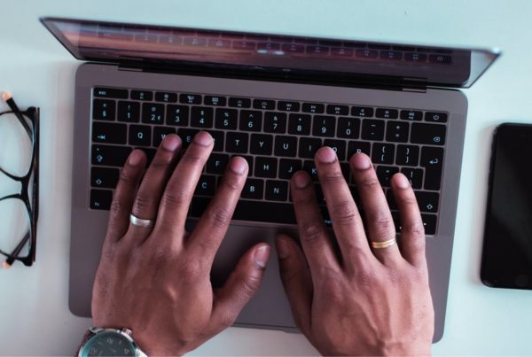 Close up of hands working on a computer