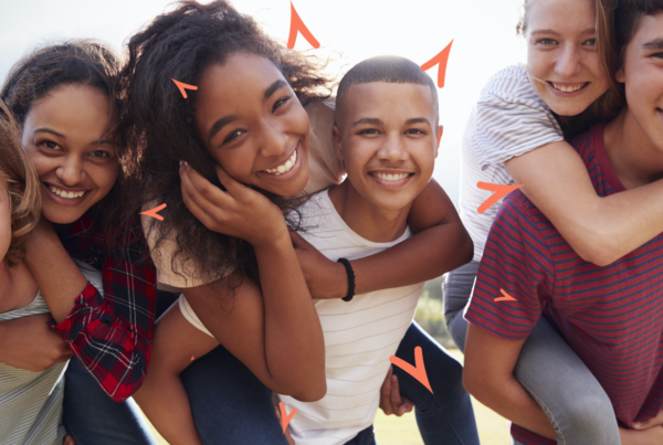 Three teens giving piggy back rides to three other teens.