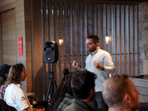 Presenter standing in front of a group of employees during an offsite event.