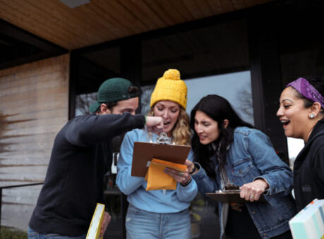 group of people huddled together looking at a clipboard