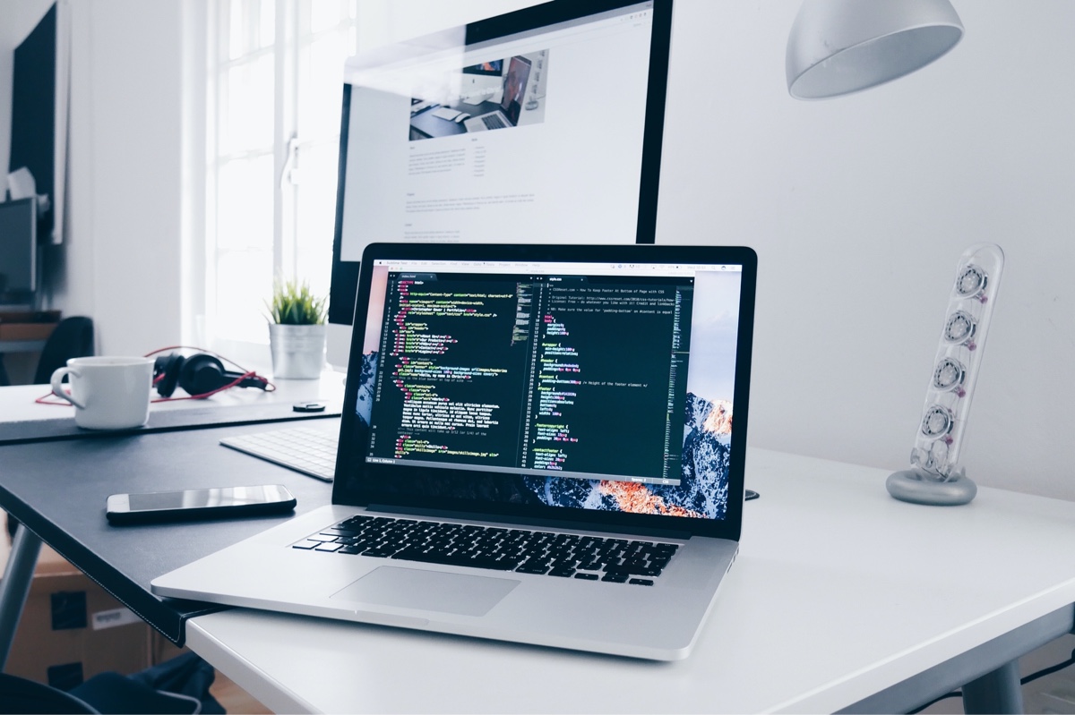 A home office with laptop with computer code